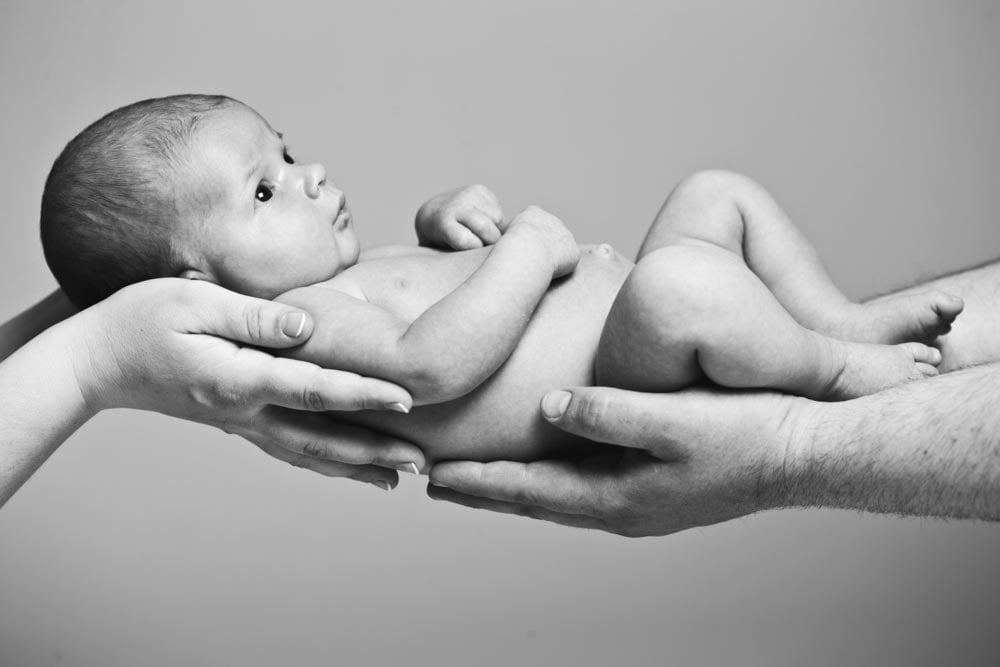 Baby photography mother and father holding newborn