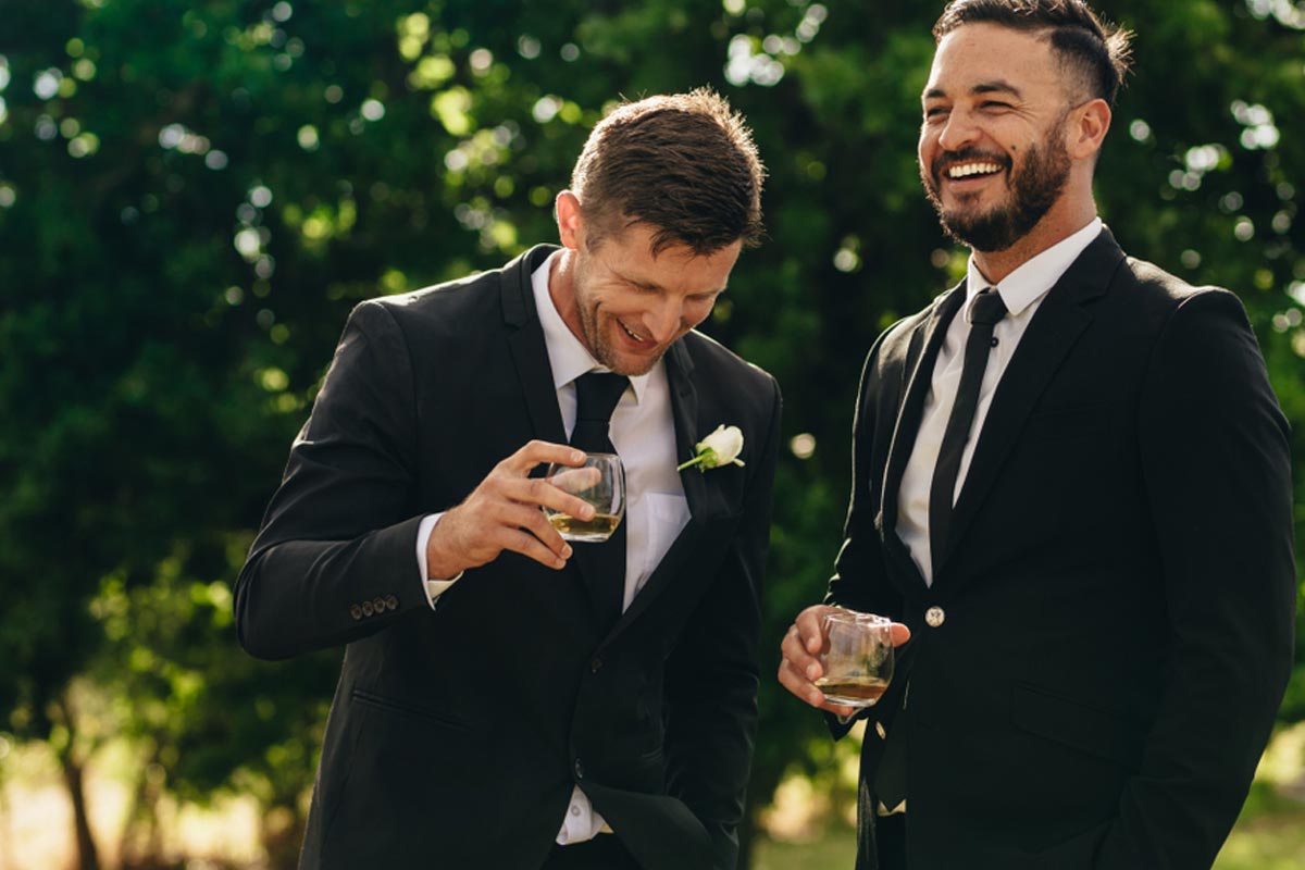 Groom and best man in rental tux partying after wedding