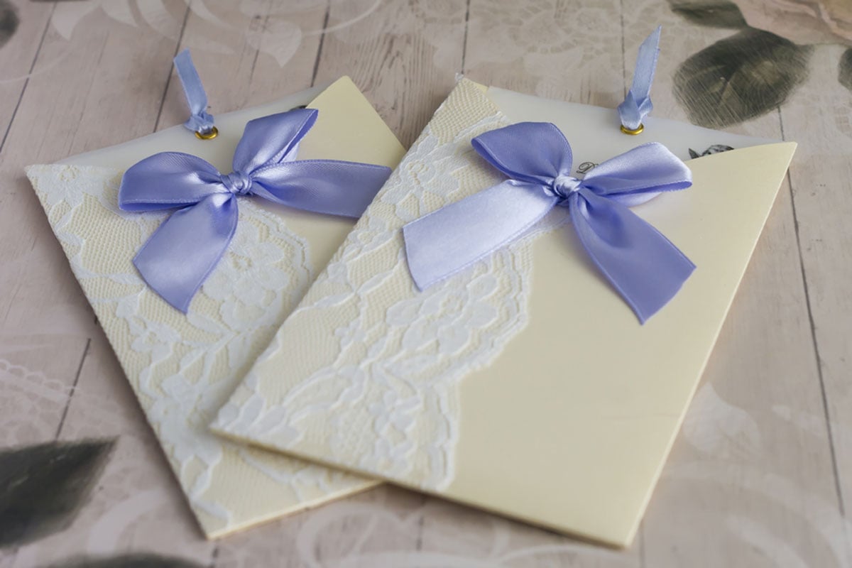 Lace edged top insert wedding invitation envelope with lavender bow and ribbon